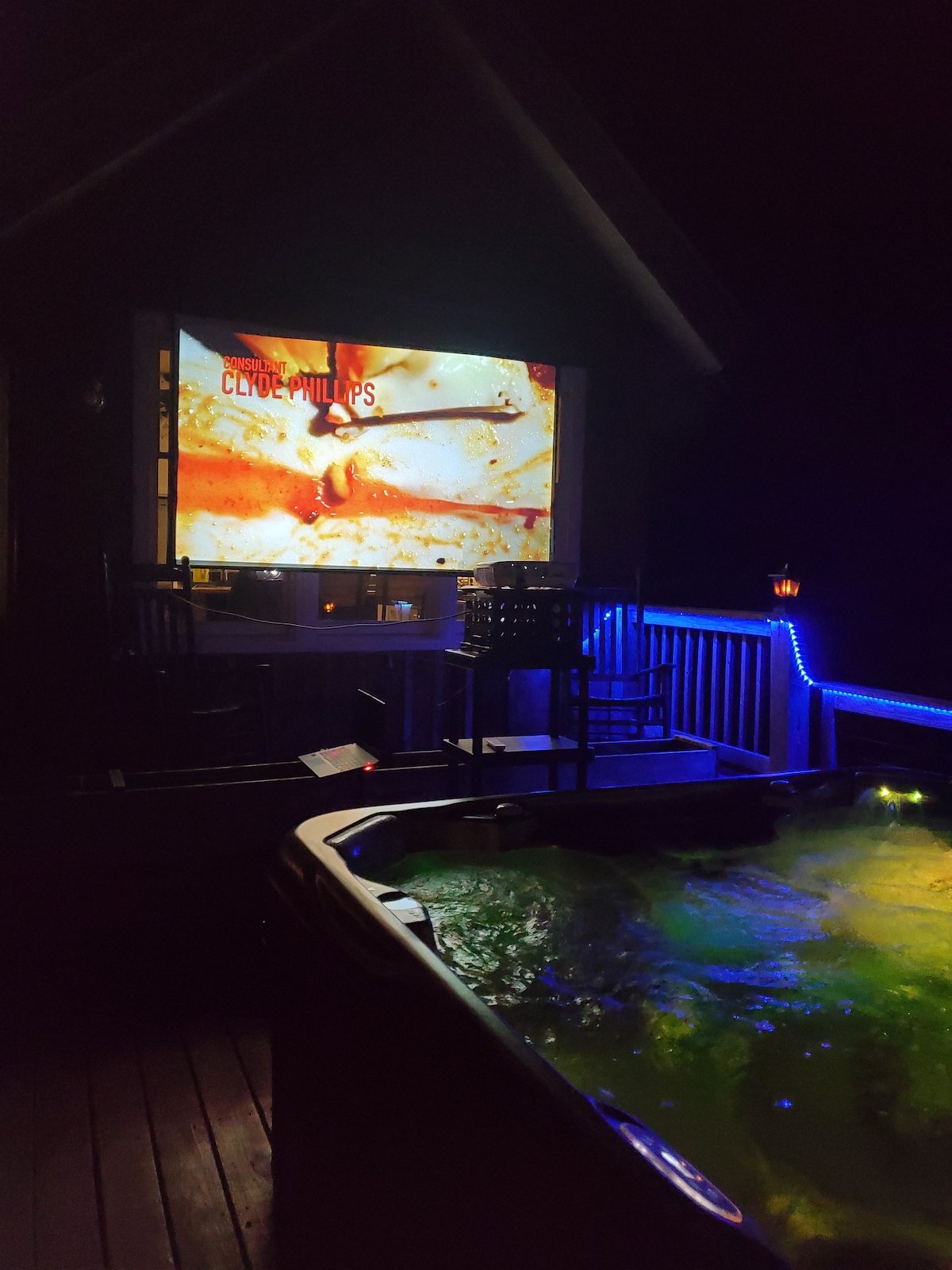 Outdoor movie theater with hot tub at night